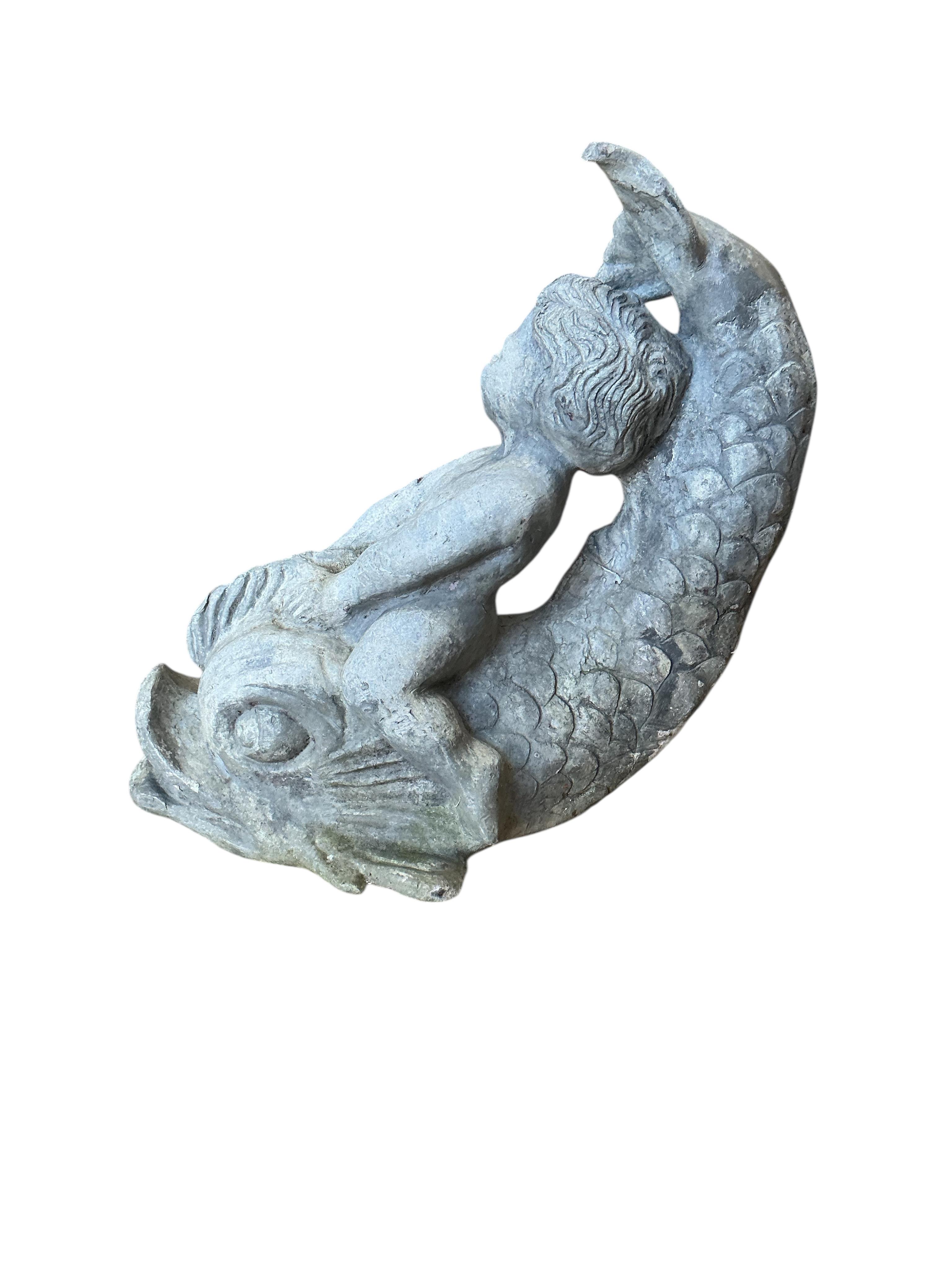 A 19th century lead putti riding a dolphin, height 30cm